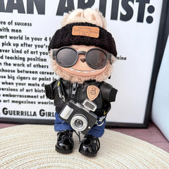Bear Brand Black Leather Jacket + Deep-Cuffed Jeans + Black Flipped-Brim Hat + Lace-Up Black Dress Shoes + Black Camera + Black Sunglasses