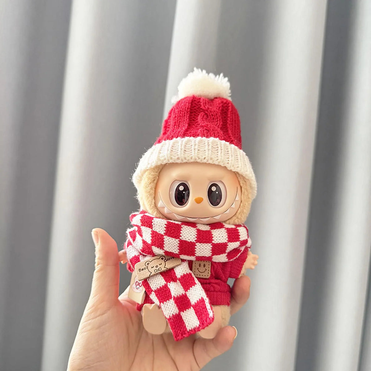 White Bobble Hat With Red Stripes + Red And White Checkered Scarf + Red Smiley Pin Sweater